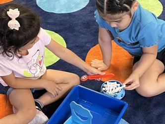 Two children playing with a math game