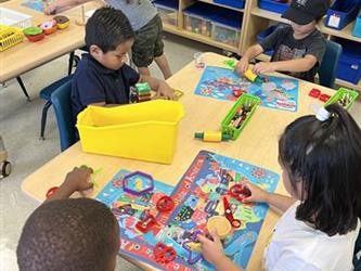 Four children playing with playdough