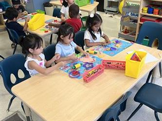 Tk students playing with playdough