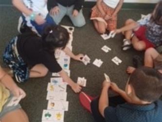 A group of first graders playing a matching alphabet puzzle